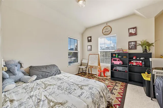 a bedroom with bed and a window