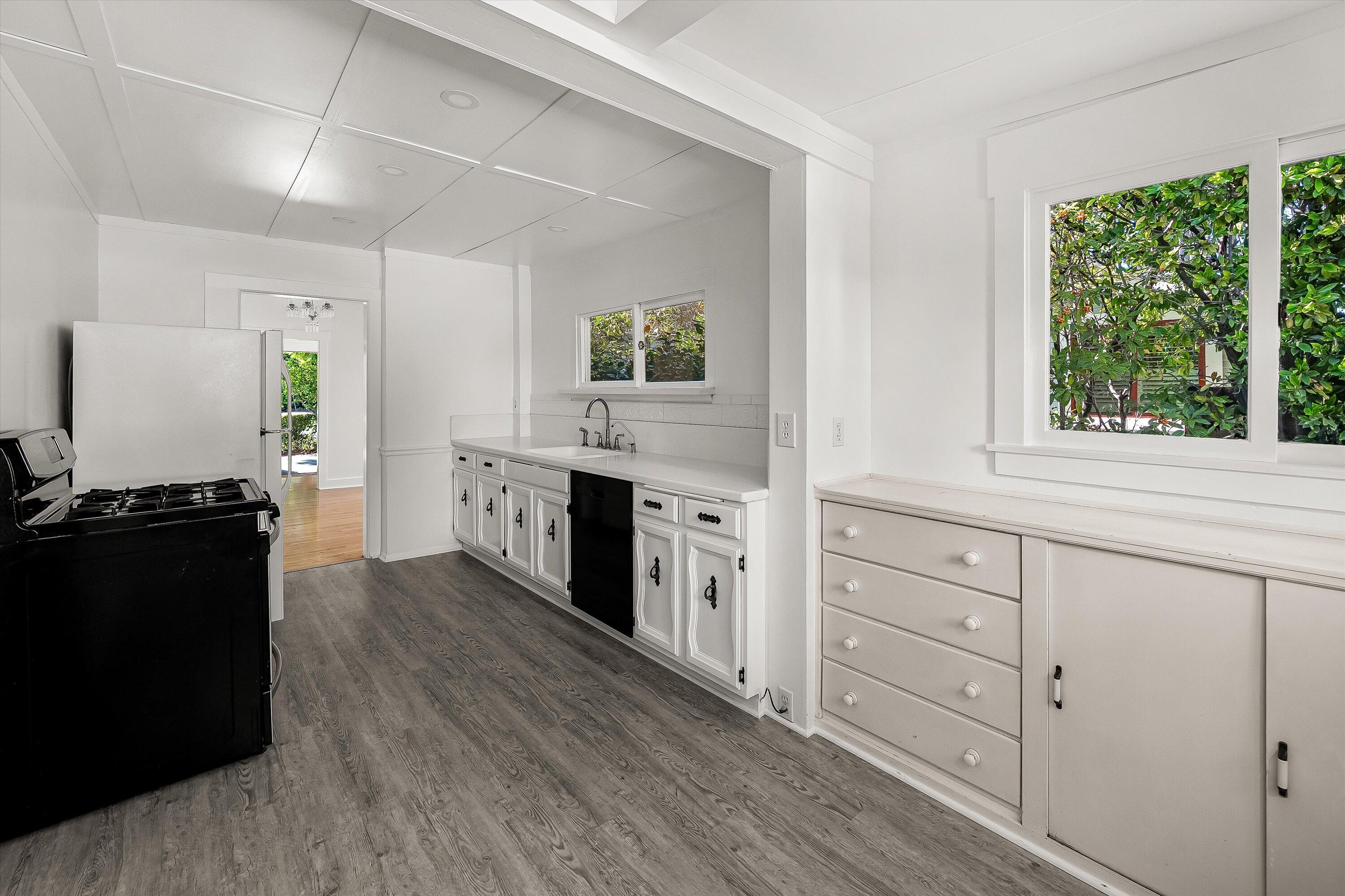 532 Brinkerhoff Avenue Santa Barbara, CA 93101 - Photo 12 of 30 a kitchen with granite countertop white cabinets and appliances