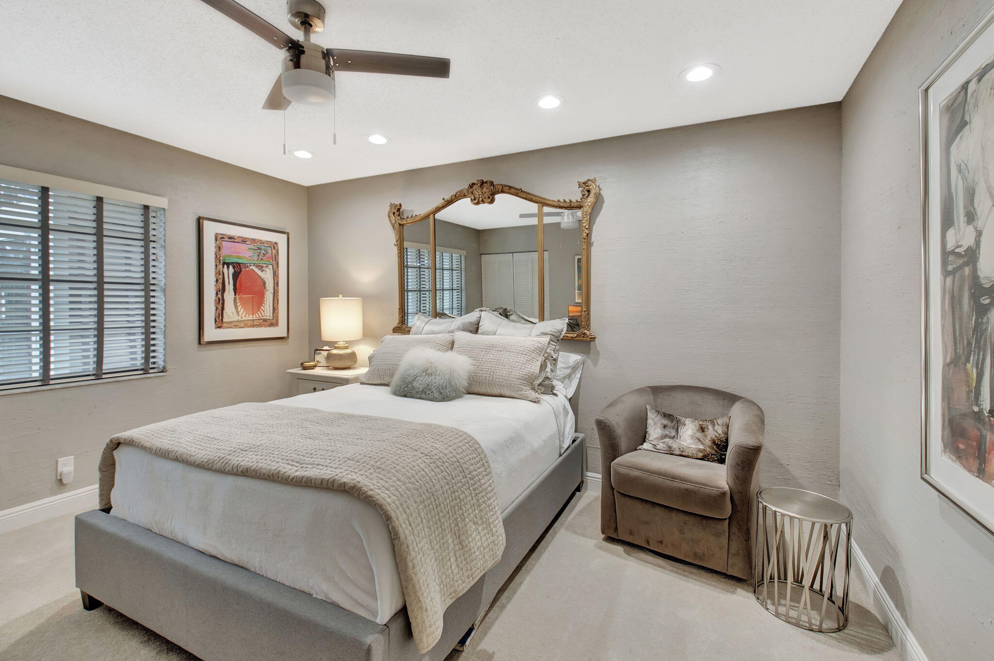 27 Eastgate Drive, Unit C Boynton Beach, FL 33436 - Photo 31 of 87 a spacious bedroom with a bed and a chandelier