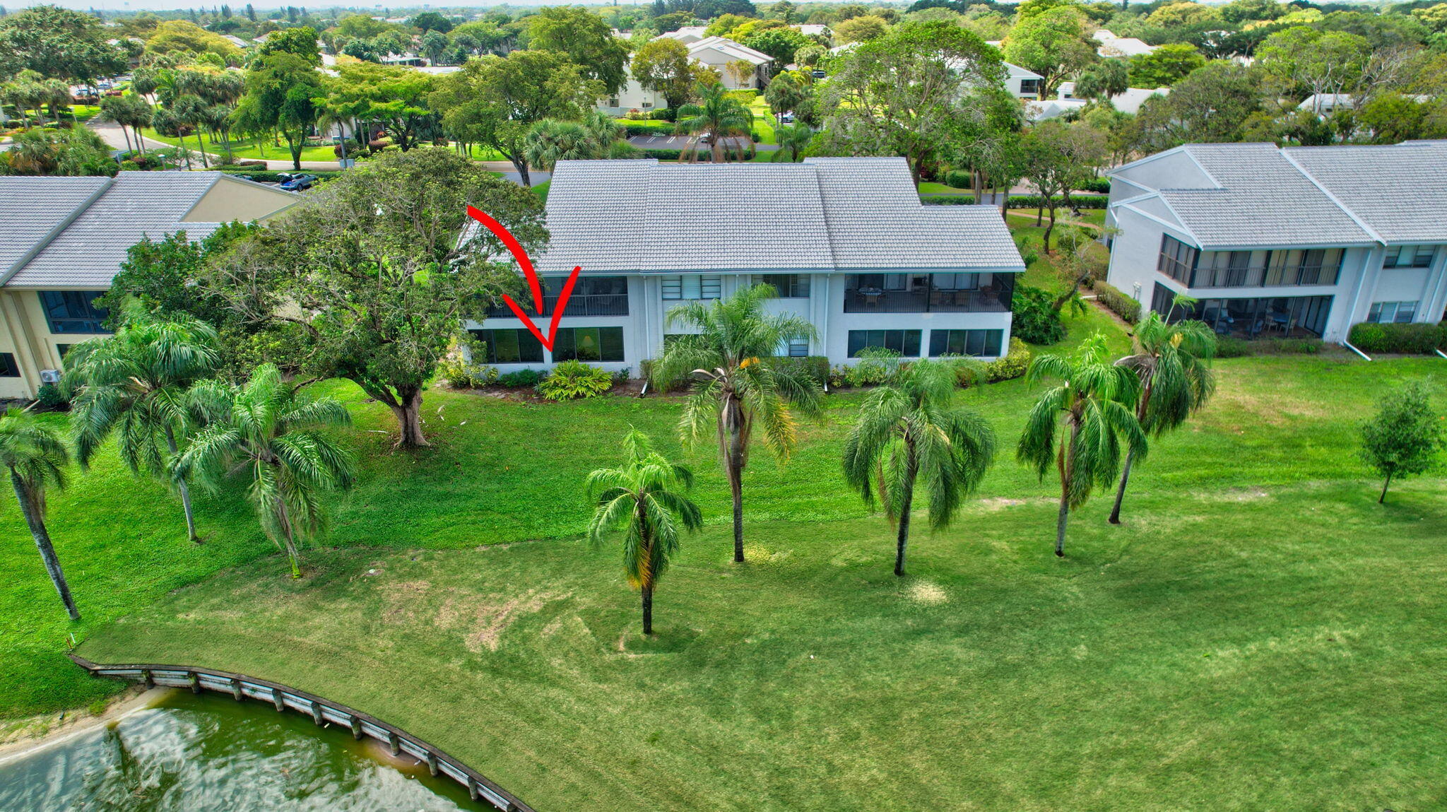27 Eastgate Drive, Unit C Boynton Beach, FL 33436 - Photo 55 of 87 a view of house with backyard and a patio