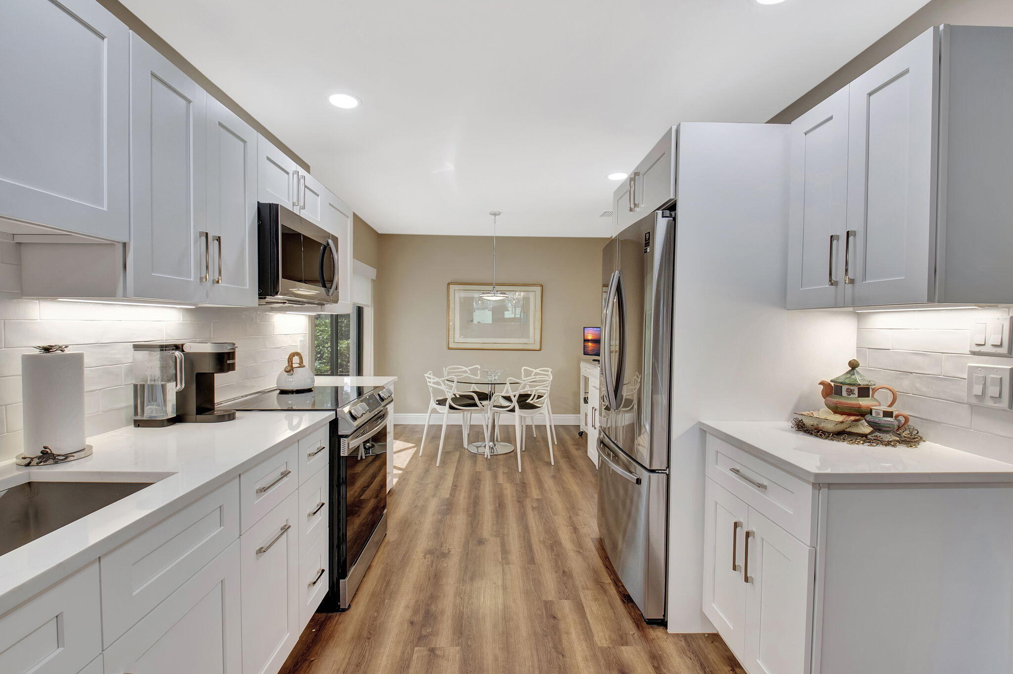 27 Eastgate Drive, Unit C Boynton Beach, FL 33436 - Photo 8 of 87 a kitchen with a sink stove cabinets and refrigerator