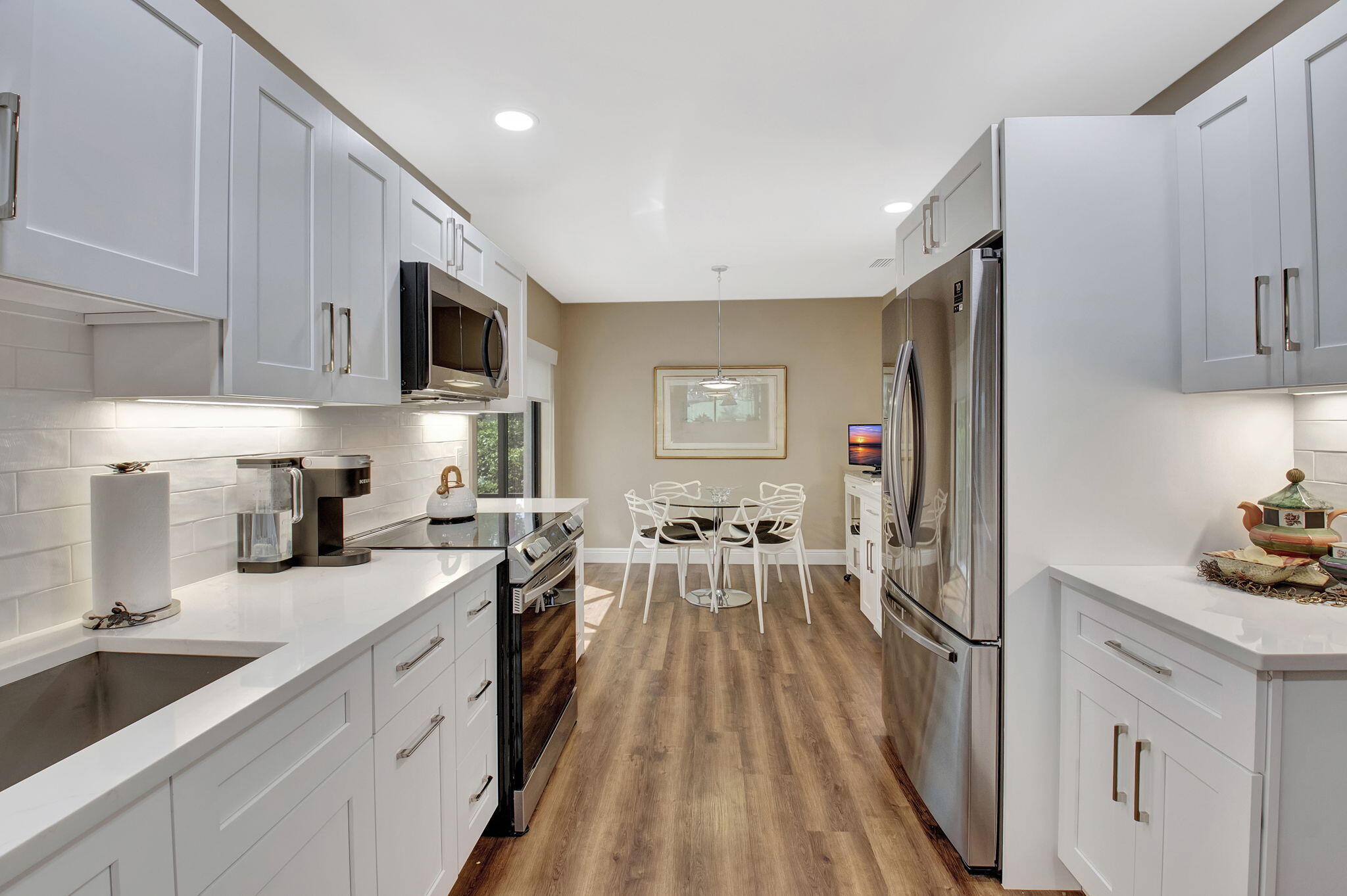 27 Eastgate Drive, Unit C Boynton Beach, FL 33436 - Photo 9 of 87 a kitchen with granite countertop lots of counter top space a sink a refrigerator and cabinets
