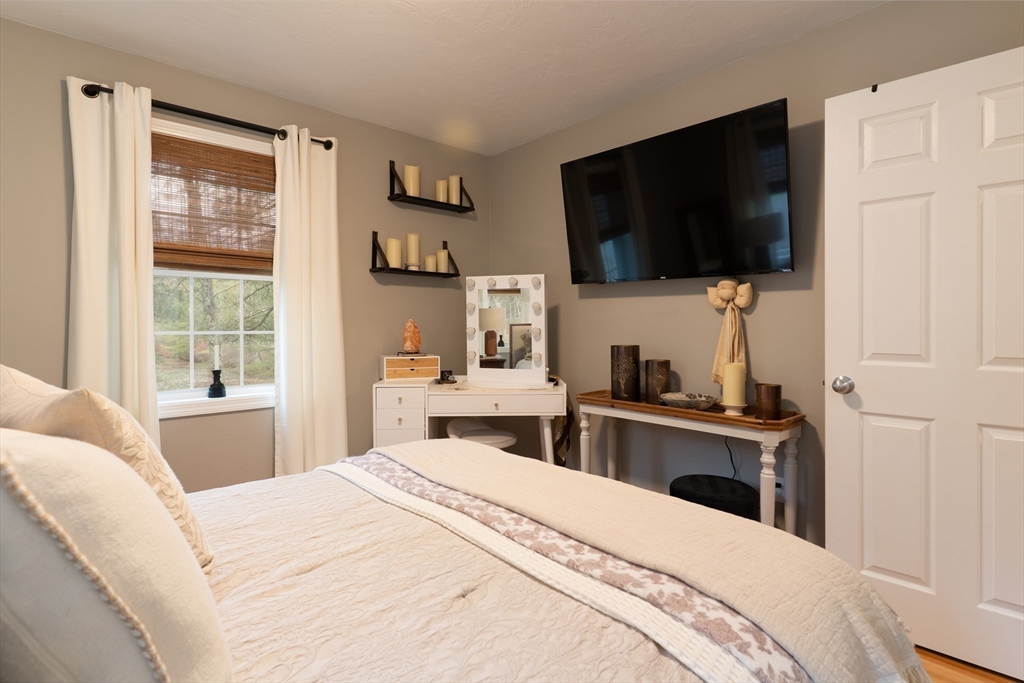 1 Leno Road Holland, MA 01521 - Photo 23 of 40 a bedroom with a bed and a flat tv screen on the dresser