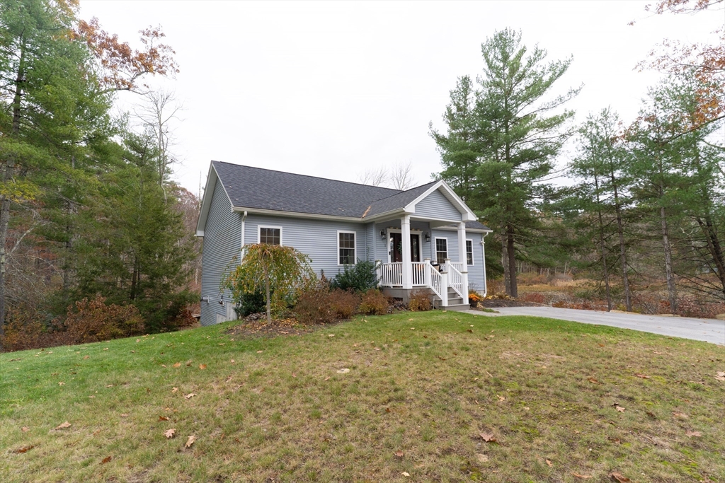1 Leno Road Holland, MA 01521 - Photo 26 of 40 a front view of a house with a yard and garage