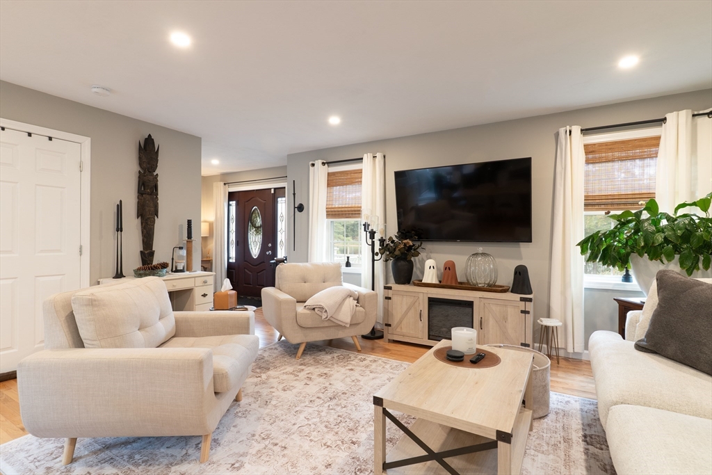 1 Leno Road Holland, MA 01521 - Photo 6 of 40 a living room with furniture a flat screen tv and a large window