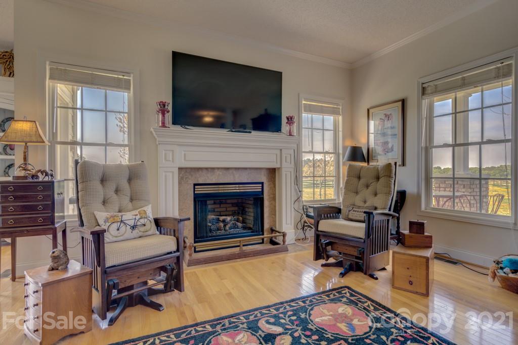 1481 Airport Road Rutherfordton, NC 28139 - Photo 22 of 47 a living room with furniture a flat screen tv and a fireplace