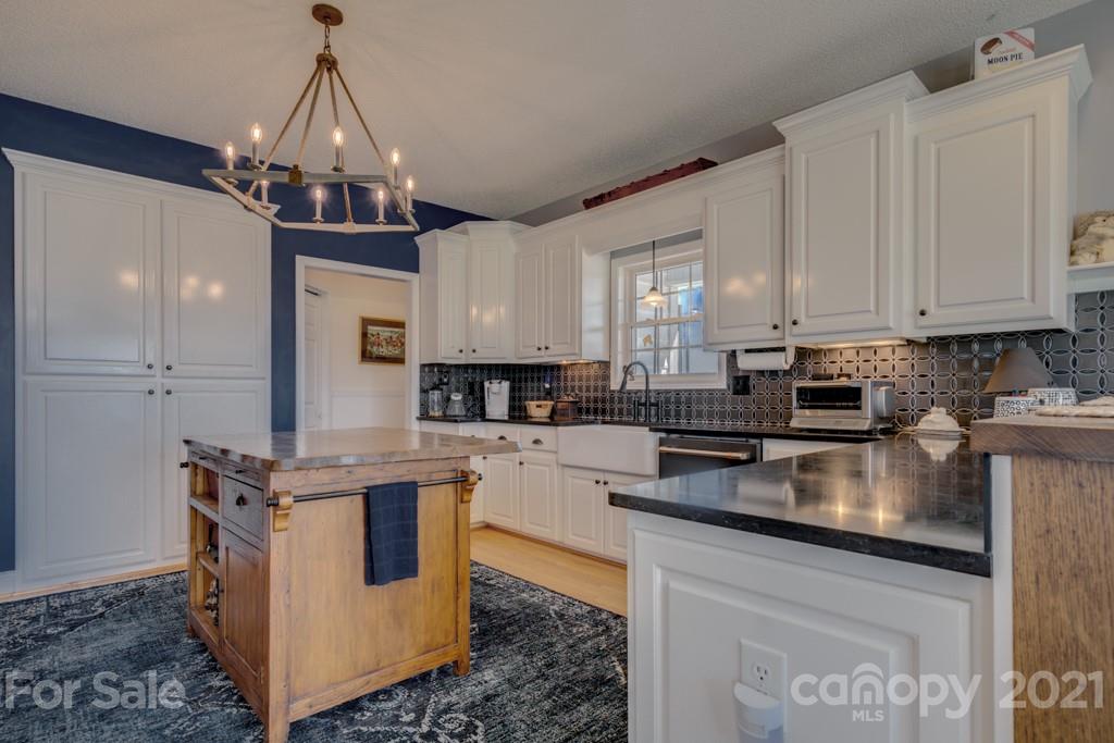1481 Airport Road Rutherfordton, NC 28139 - Photo 27 of 47 a kitchen with stainless steel appliances granite countertop a stove top oven a sink a counter space and cabinets
