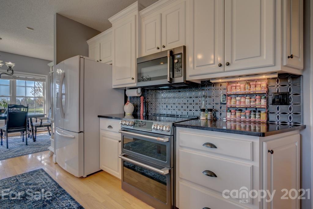 1481 Airport Road Rutherfordton, NC 28139 - Photo 29 of 47 a kitchen with stainless steel appliances granite countertop a refrigerator sink and cabinets