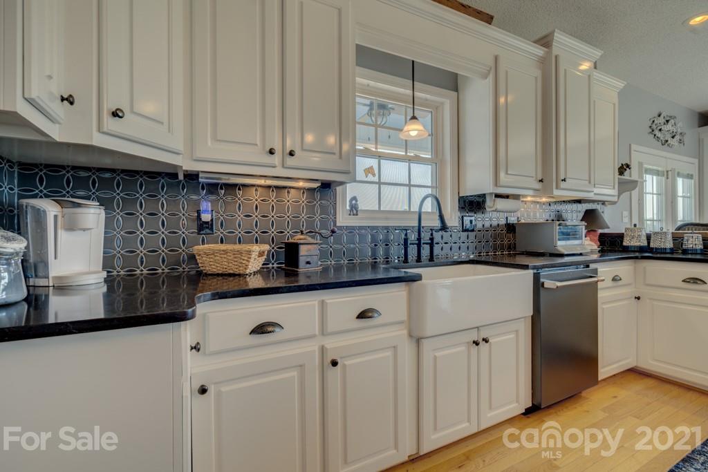 1481 Airport Road Rutherfordton, NC 28139 - Photo 31 of 47 a kitchen with stainless steel appliances granite countertop a sink a stove and cabinets