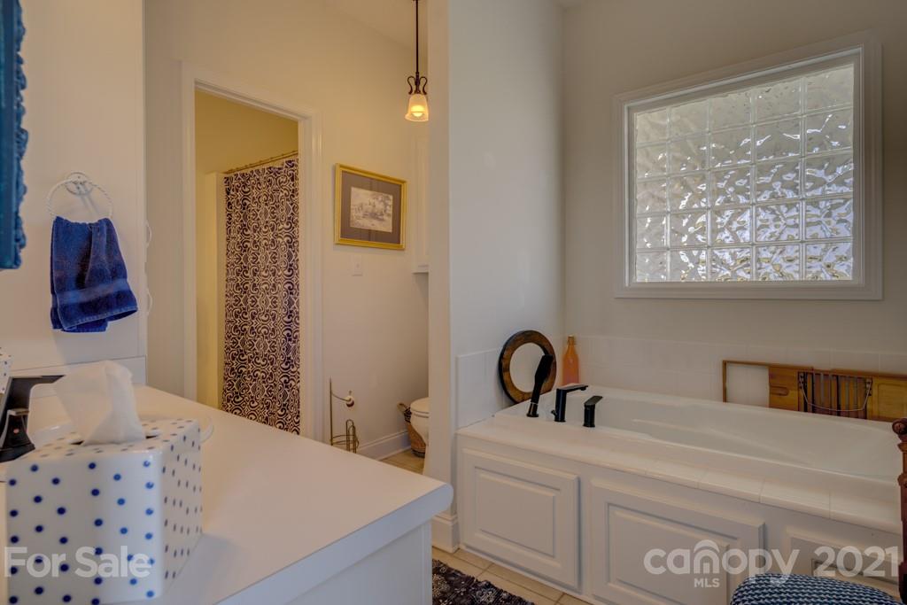 1481 Airport Road Rutherfordton, NC 28139 - Photo 35 of 47 a bedroom with a bed and a lamp