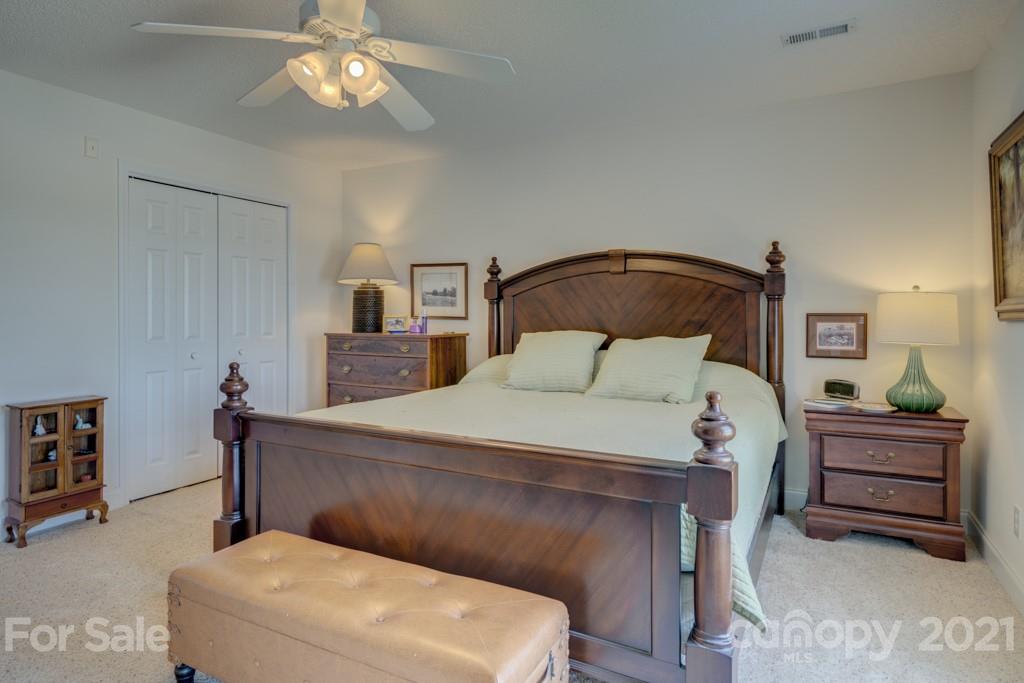1481 Airport Road Rutherfordton, NC 28139 - Photo 38 of 47 a bedroom with a bed and a chandelier