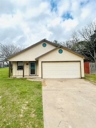 a front view of house with yard and trees
