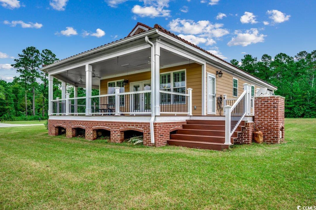 5517 Tranquil Road Conway, SC 29527 - Photo 23 of 39 Rear view of property featuring a lawn and ceiling