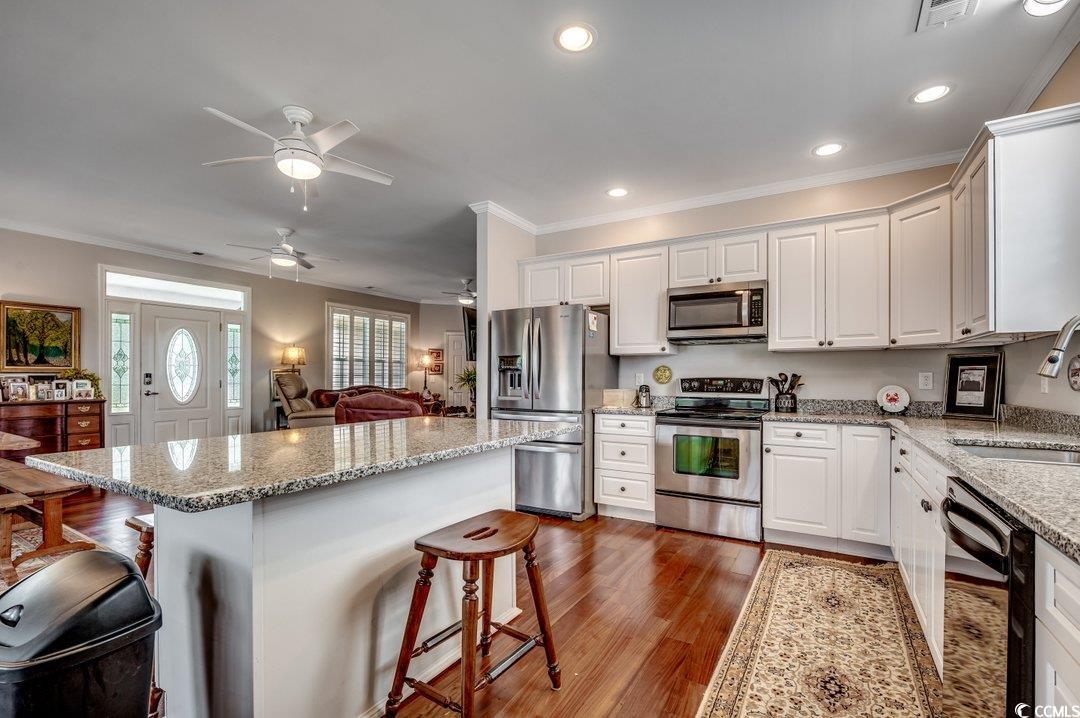 5517 Tranquil Road Conway, SC 29527 - Photo 8 of 39 Kitchen featuring white cabinets, a breakfast bar