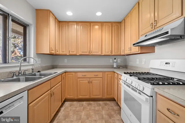 a kitchen with granite countertop cabinets stainless steel appliances and a sink