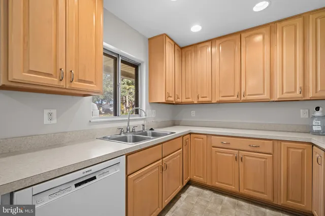 a kitchen with stainless steel appliances granite countertop a sink and dishwasher with cabinets