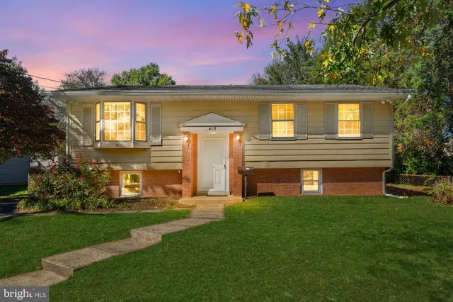 a front view of a house with a yard and lake view