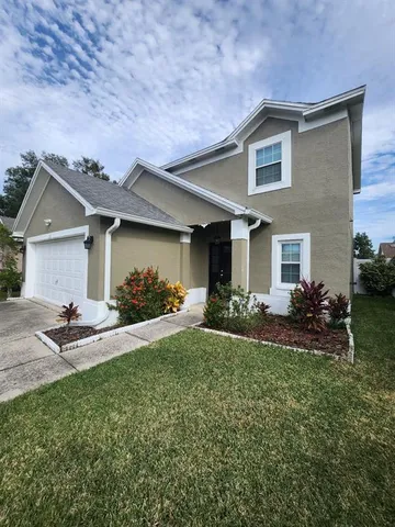 a front view of a house with a yard and garage