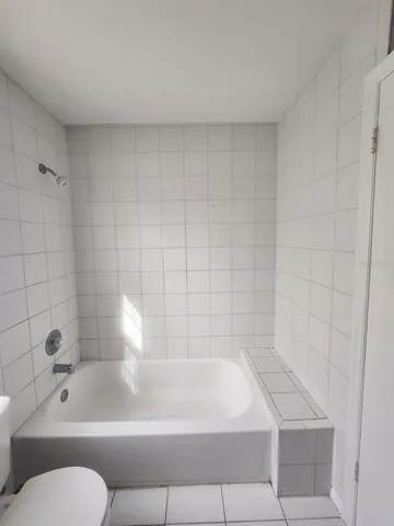a bathroom with a sink toilet and window