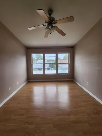 a bathroom with a granite countertop sink a toilet a mirror and a bathtub