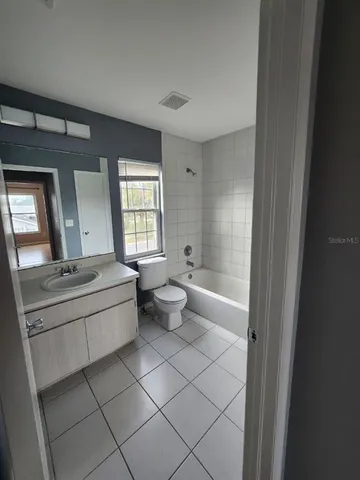 a bathroom with a sink vanity and mirror