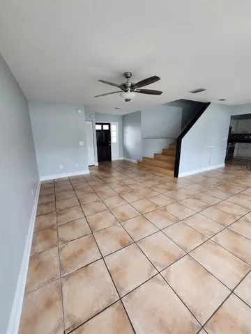 a view of a kitchen with a sink and a chandelier fan