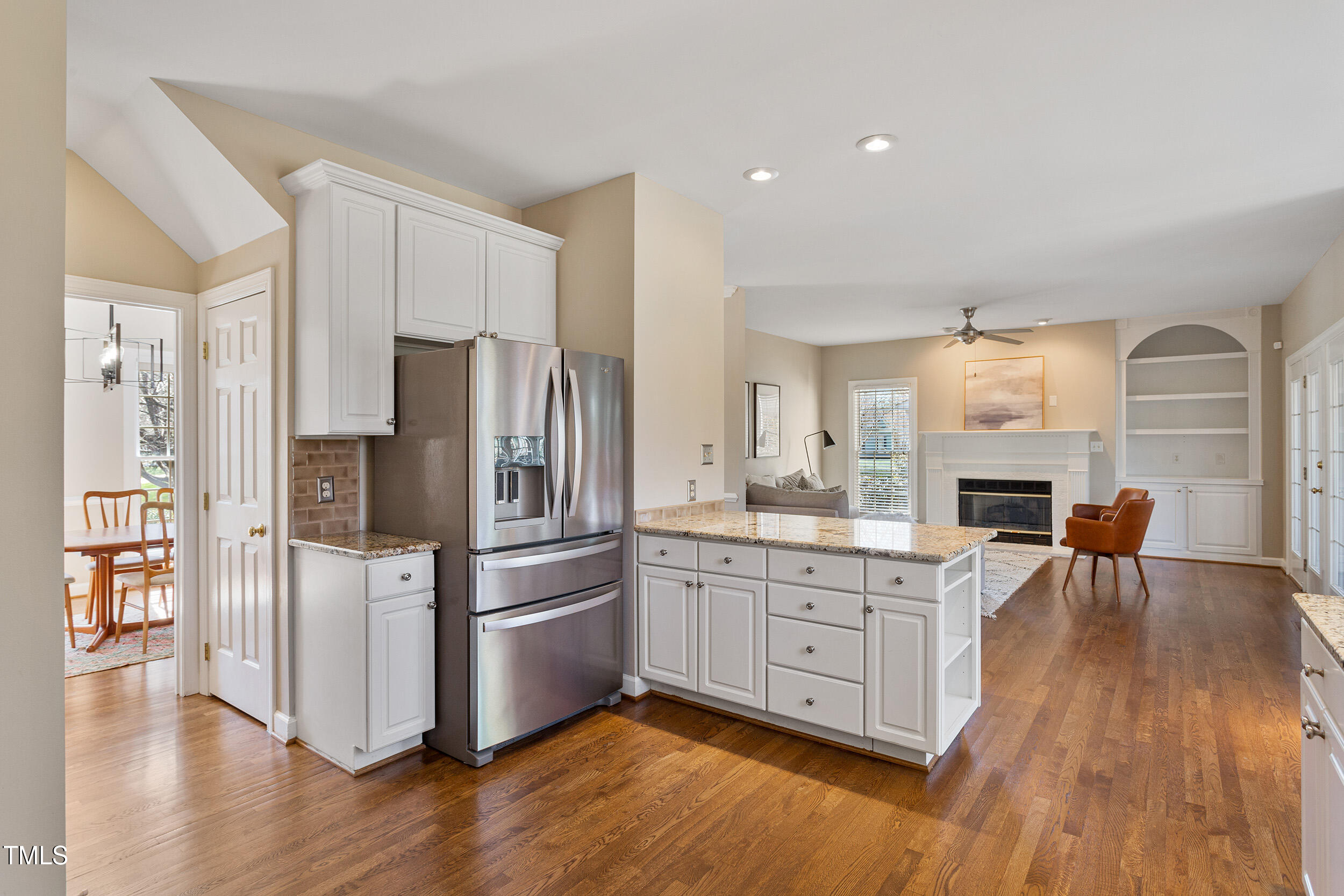 501 Nantucket Drive Cary, NC 27513 - Photo 12 of 34 a kitchen with a refrigerator a stove cabinets and wooden floor