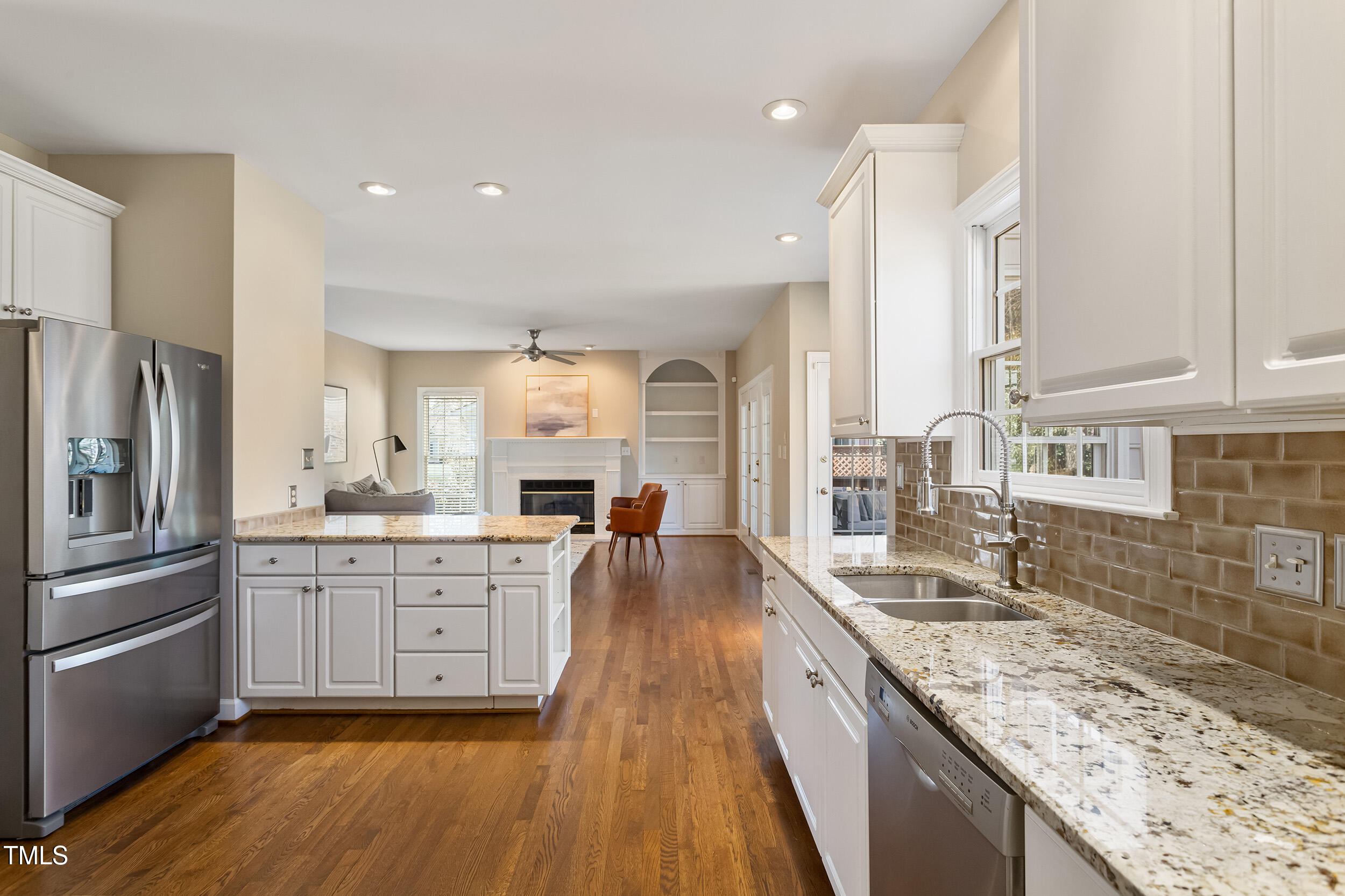 501 Nantucket Drive Cary, NC 27513 - Photo 15 of 34 a kitchen with granite countertop a sink stove and refrigerator