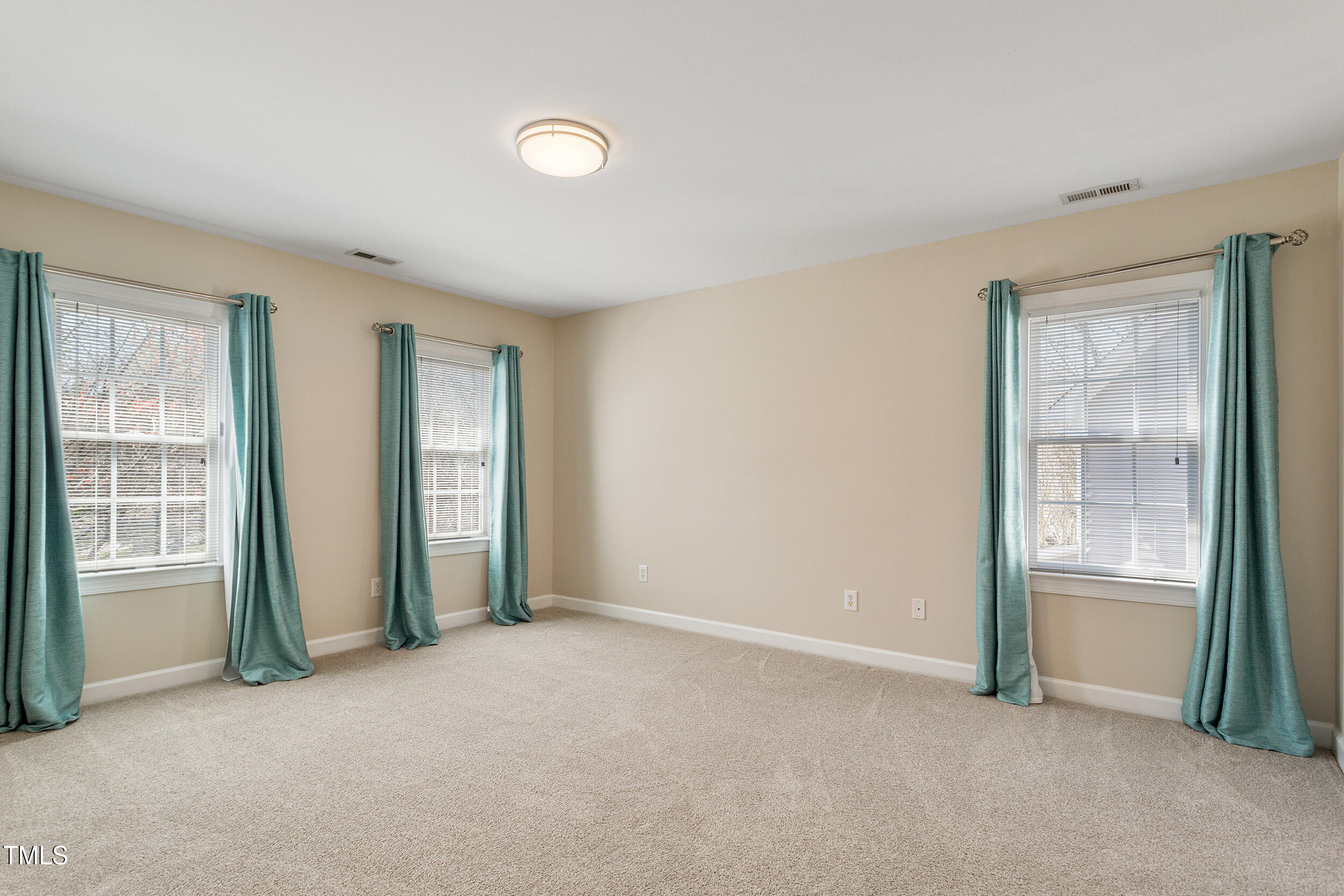 501 Nantucket Drive Cary, NC 27513 - Photo 19 of 34 an empty room with windows
