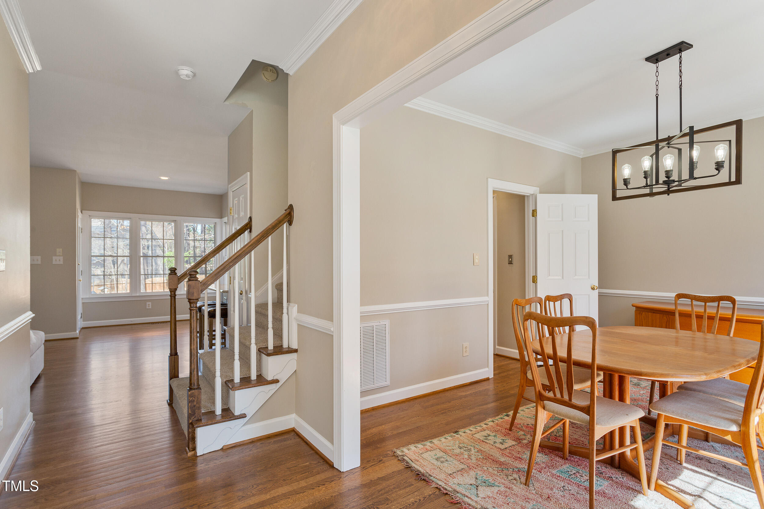 501 Nantucket Drive Cary, NC 27513 - Photo 2 of 34 a view of a dining room with hardwood floor and stairs