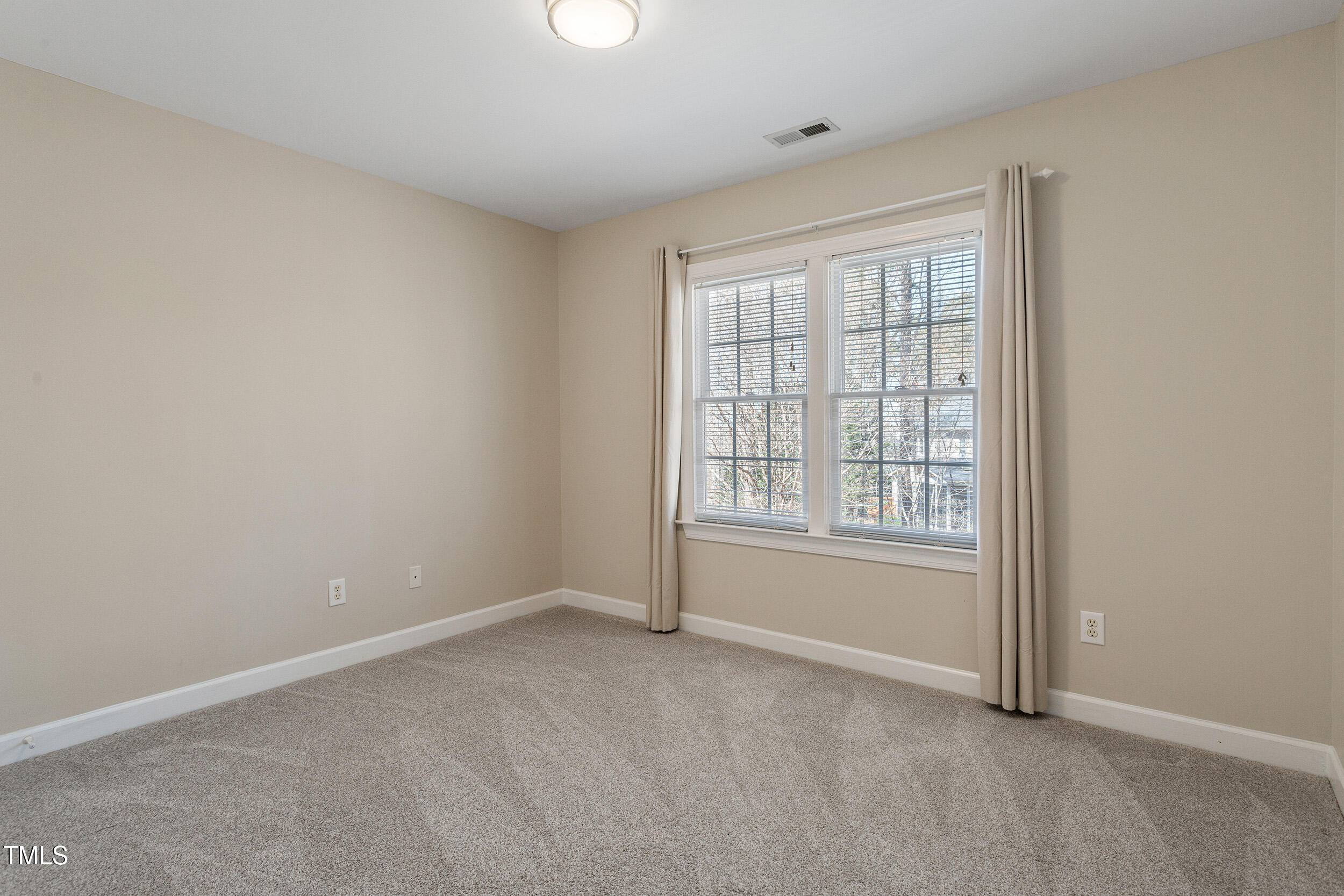 501 Nantucket Drive Cary, NC 27513 - Photo 24 of 34 an empty room with windows
