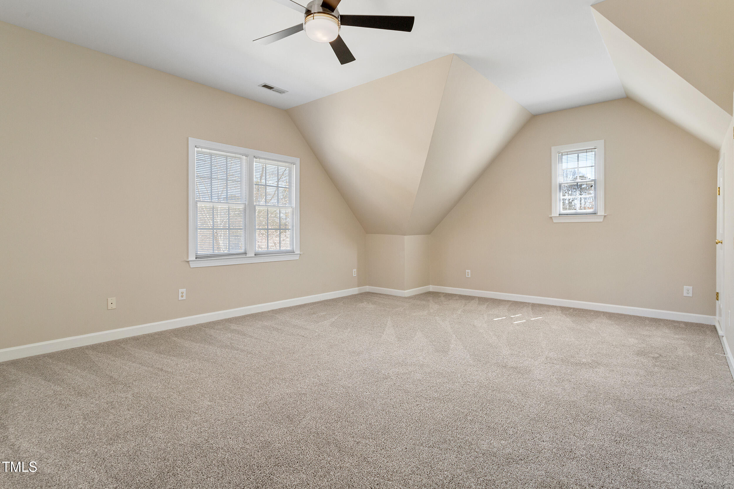 501 Nantucket Drive Cary, NC 27513 - Photo 28 of 34 en empty room with windows and ceiling fan