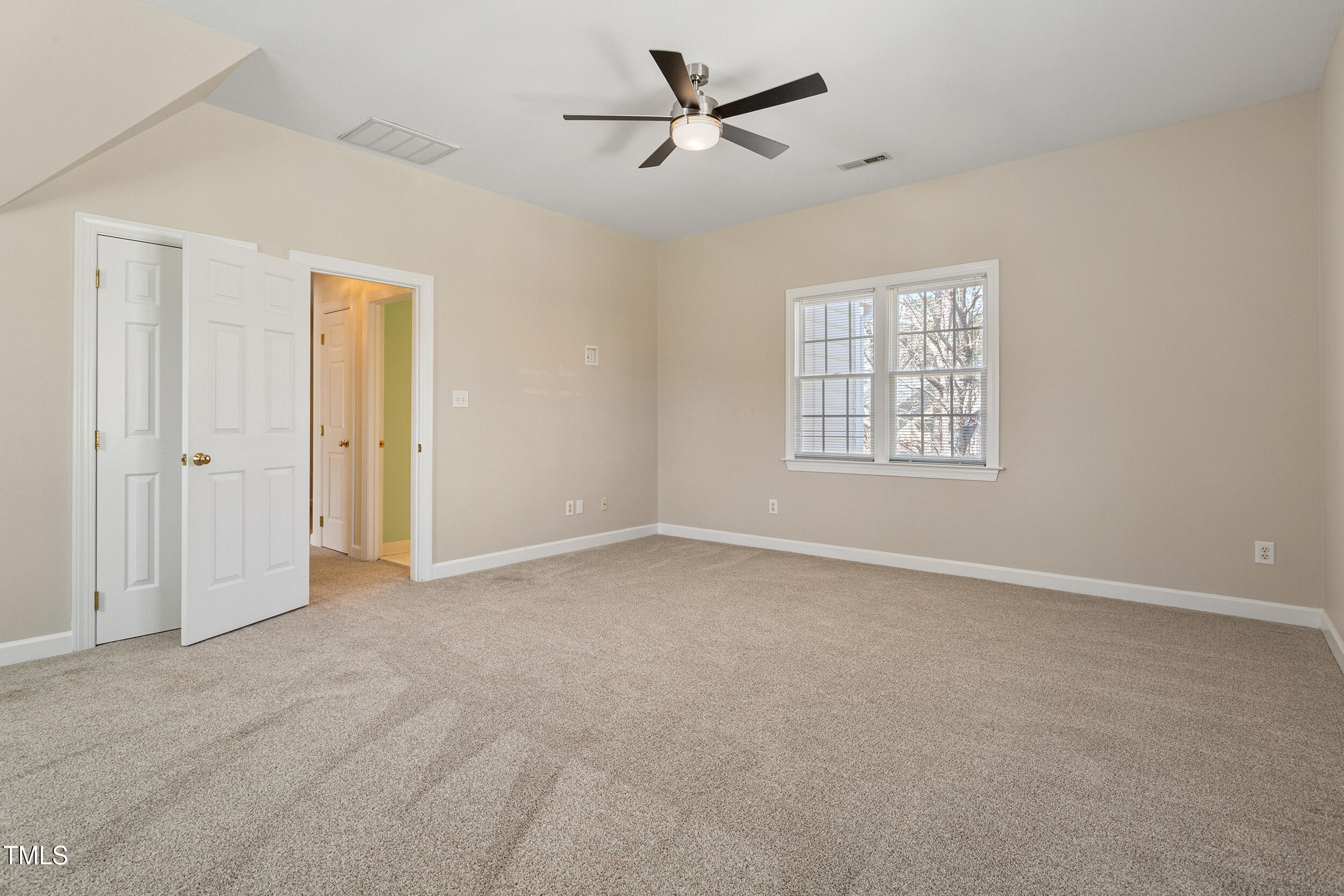 501 Nantucket Drive Cary, NC 27513 - Photo 29 of 34 an empty room with windows and fan