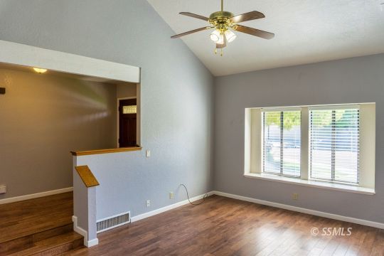 316 Mesquite Avenue Ridgecrest, CA 93555 - Photo 7 of 38 a view of an empty room with a window and wooden floor