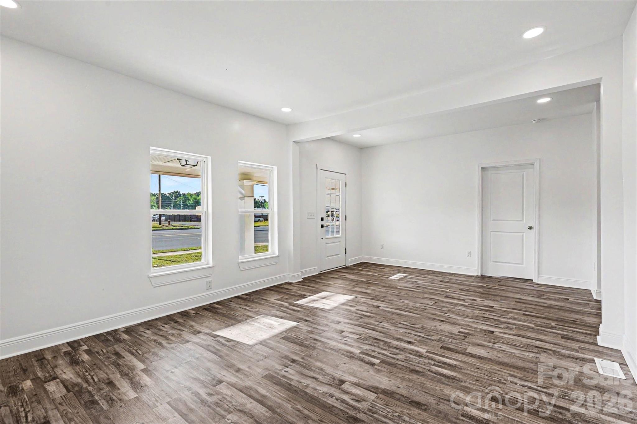 405 Aquadale Road Albemarle, NC 28001 - Photo 7 of 29 a view of an empty room with wooden floor and a window