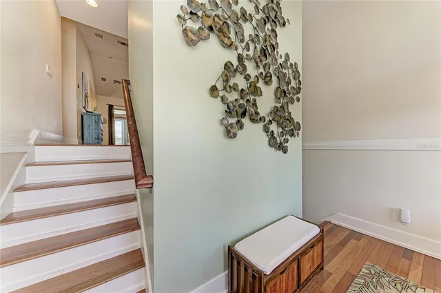 a living room with furniture kitchen view and a large window