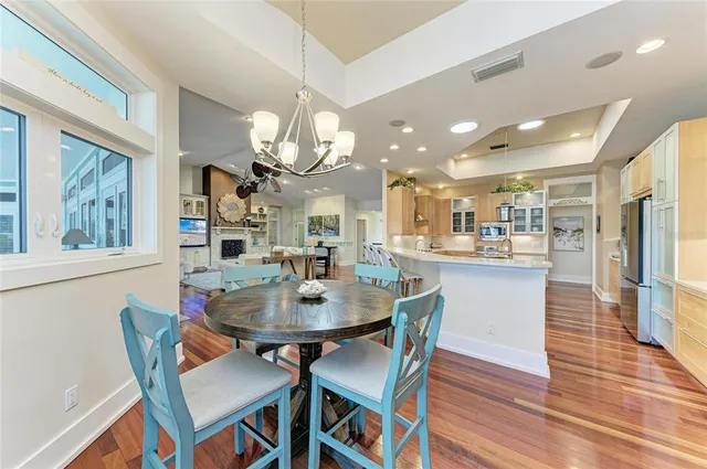 a spacious bedroom with a bed and a chandelier