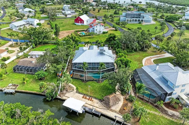 an aerial view of a house with a yard basket ball court and outdoor seating