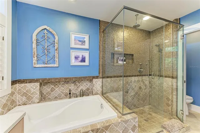 a bedroom with a bed a table and window