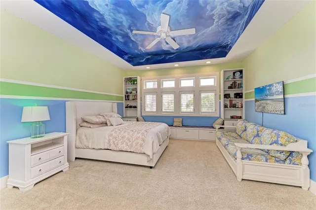 a spacious bedroom with a bed a couch and cabinet