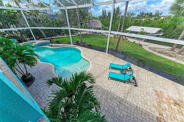 a view of a patio with a table and chairs under an umbrella