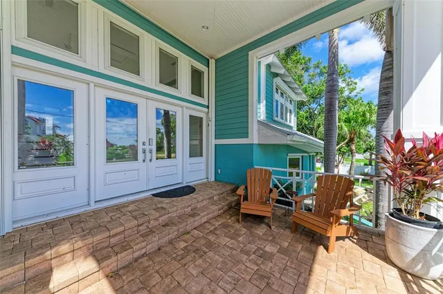 a living room with furniture wooden floor and a large window