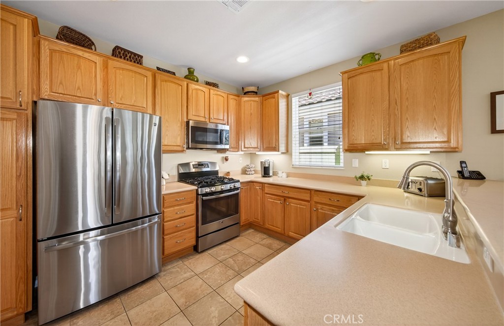 1760 Scottsdale Road Beaumont, CA 92223 - Photo 7 of 37 KITCHEN WITH CORIAN COUNTERS. GENEROUS CABINETRY.