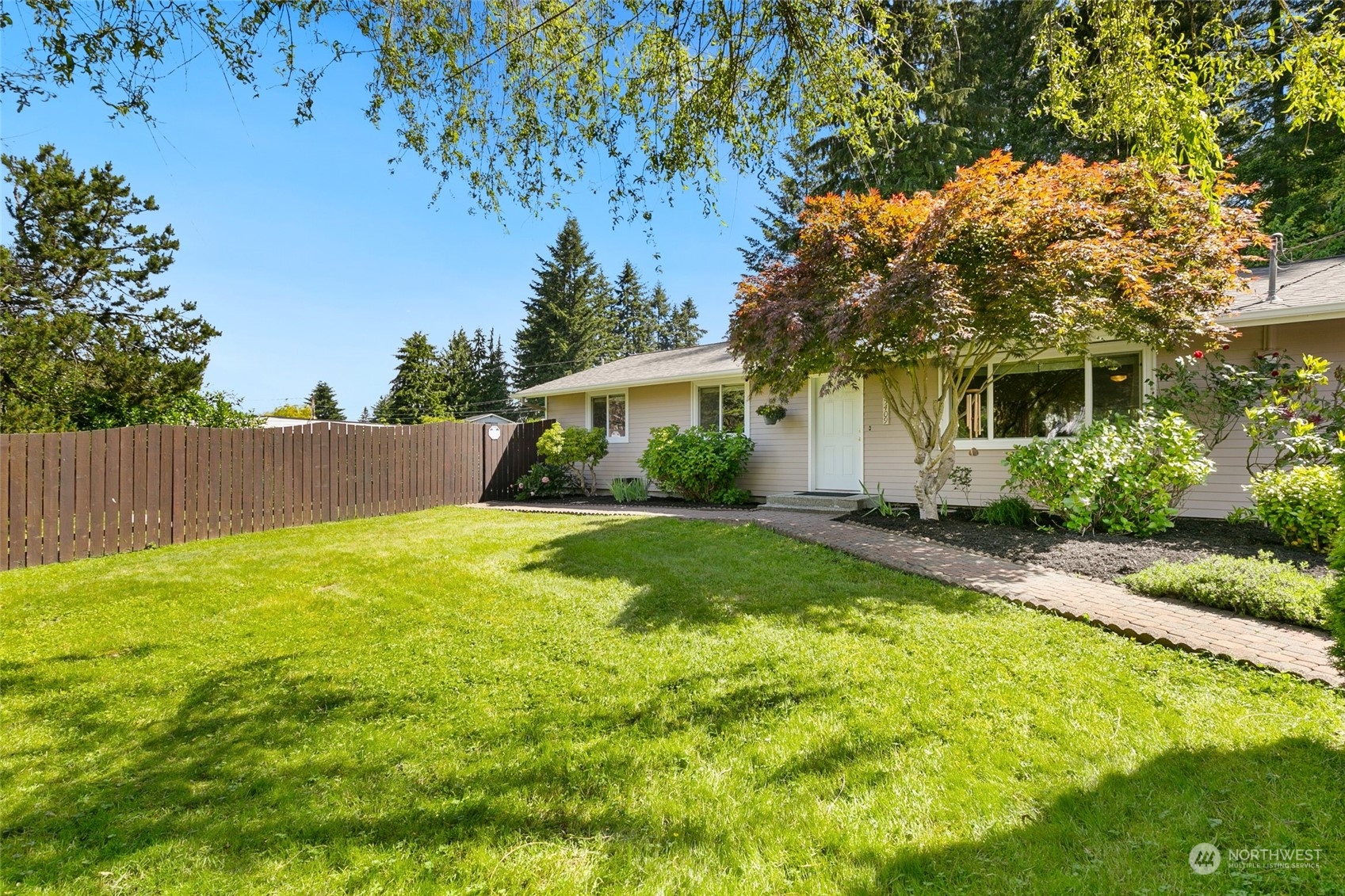 a view of backyard of house with green space