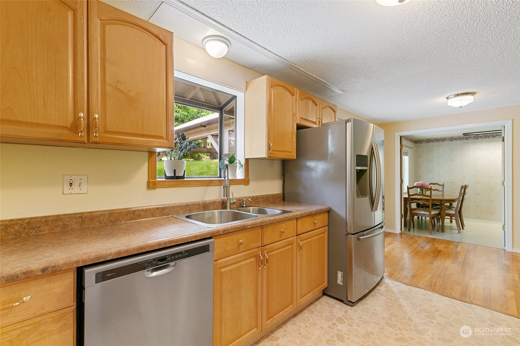 5409 Seahurst Avenue Everett, WA 98203 - Photo 12 of 26 a kitchen with stainless steel appliances granite countertop a sink refrigerator and cabinets