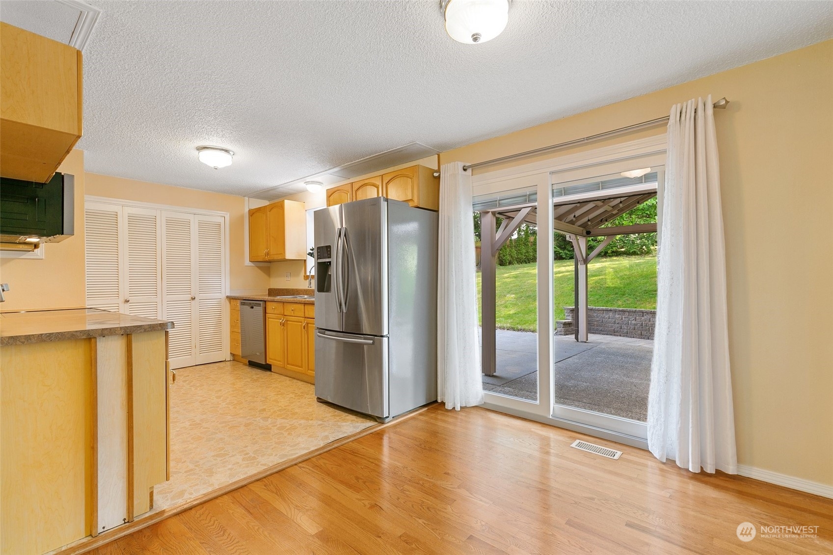 5409 Seahurst Avenue Everett, WA 98203 - Photo 8 of 26 a kitchen with stainless steel appliances a refrigerator and a stove top oven