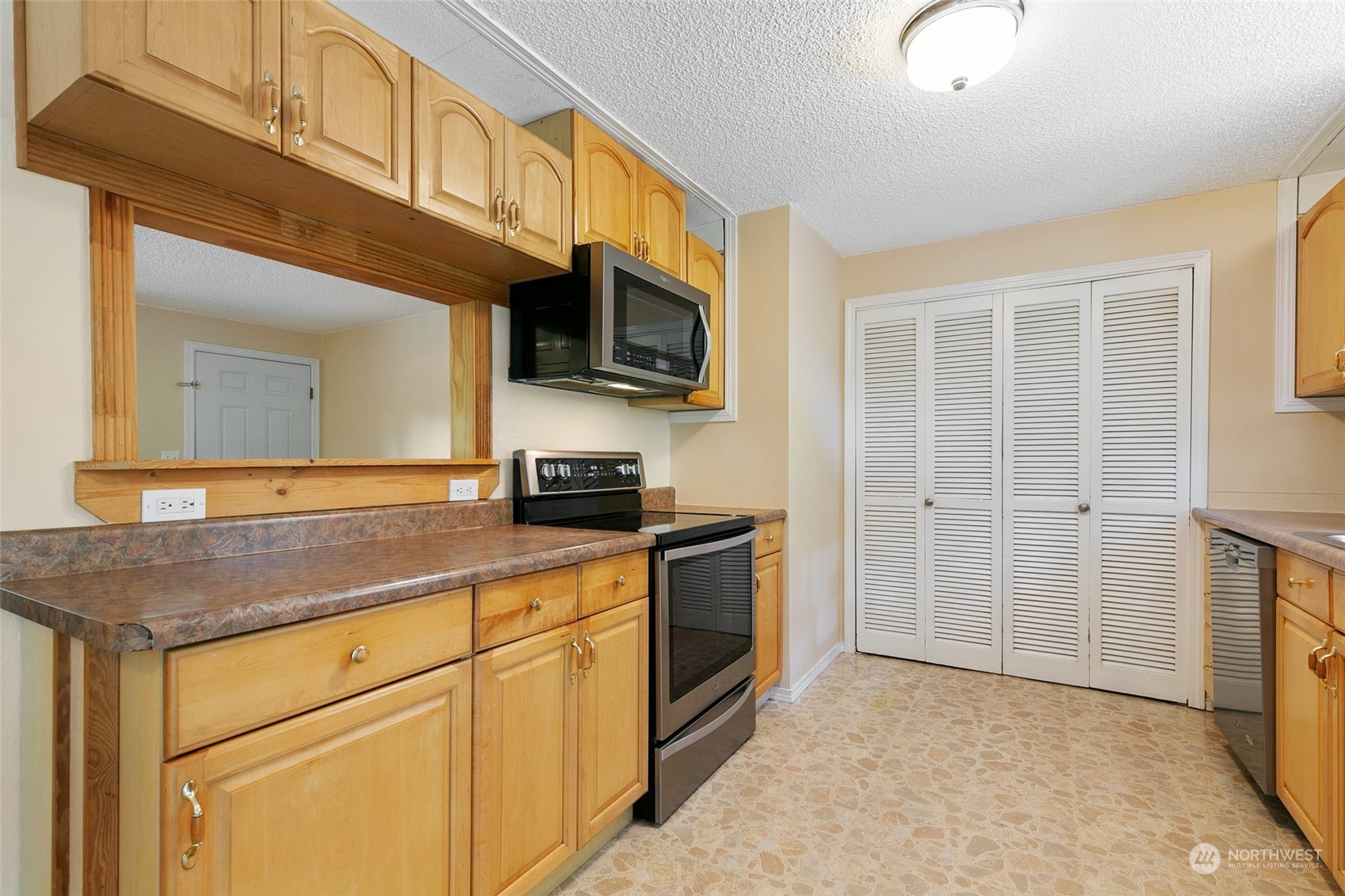 5409 Seahurst Avenue Everett, WA 98203 - Photo 9 of 26 a kitchen with stainless steel appliances granite countertop a stove a sink and a microwave