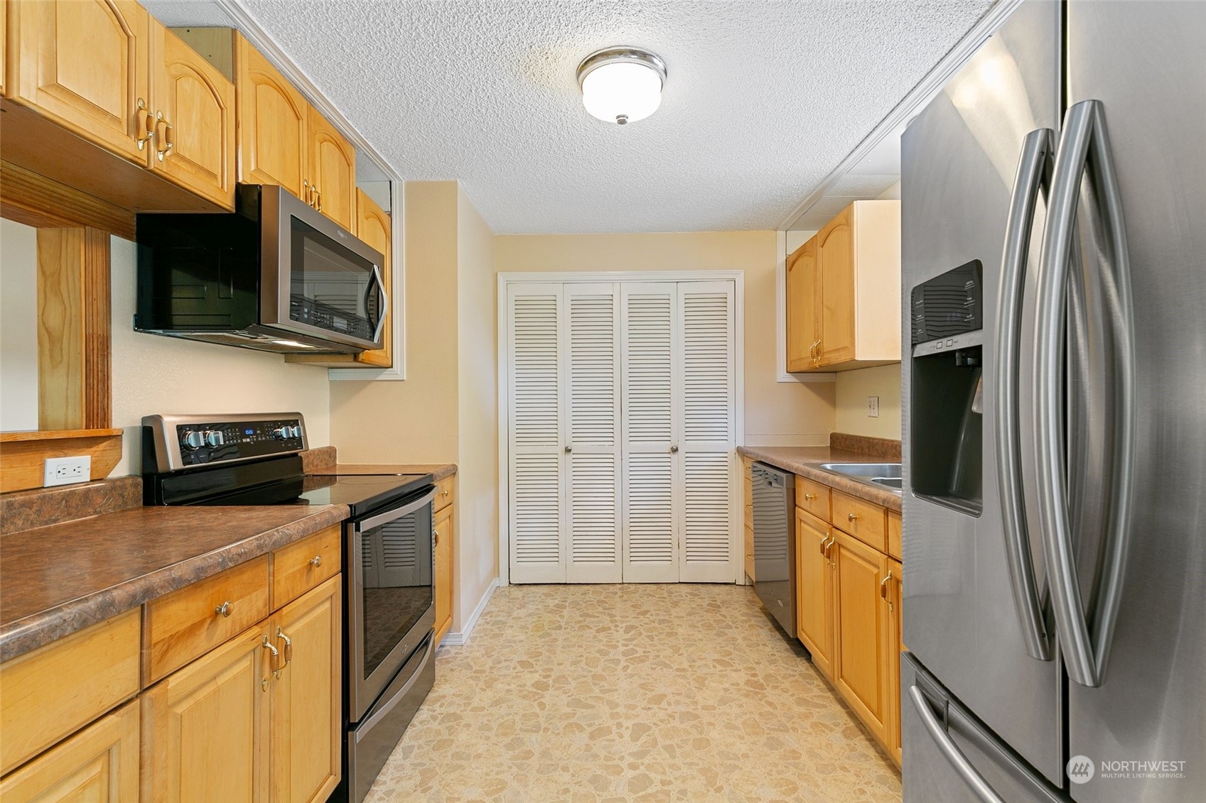5409 Seahurst Avenue Everett, WA 98203 - Photo 10 of 26 a kitchen with stainless steel appliances granite countertop a refrigerator a stove top oven a sink and dishwasher