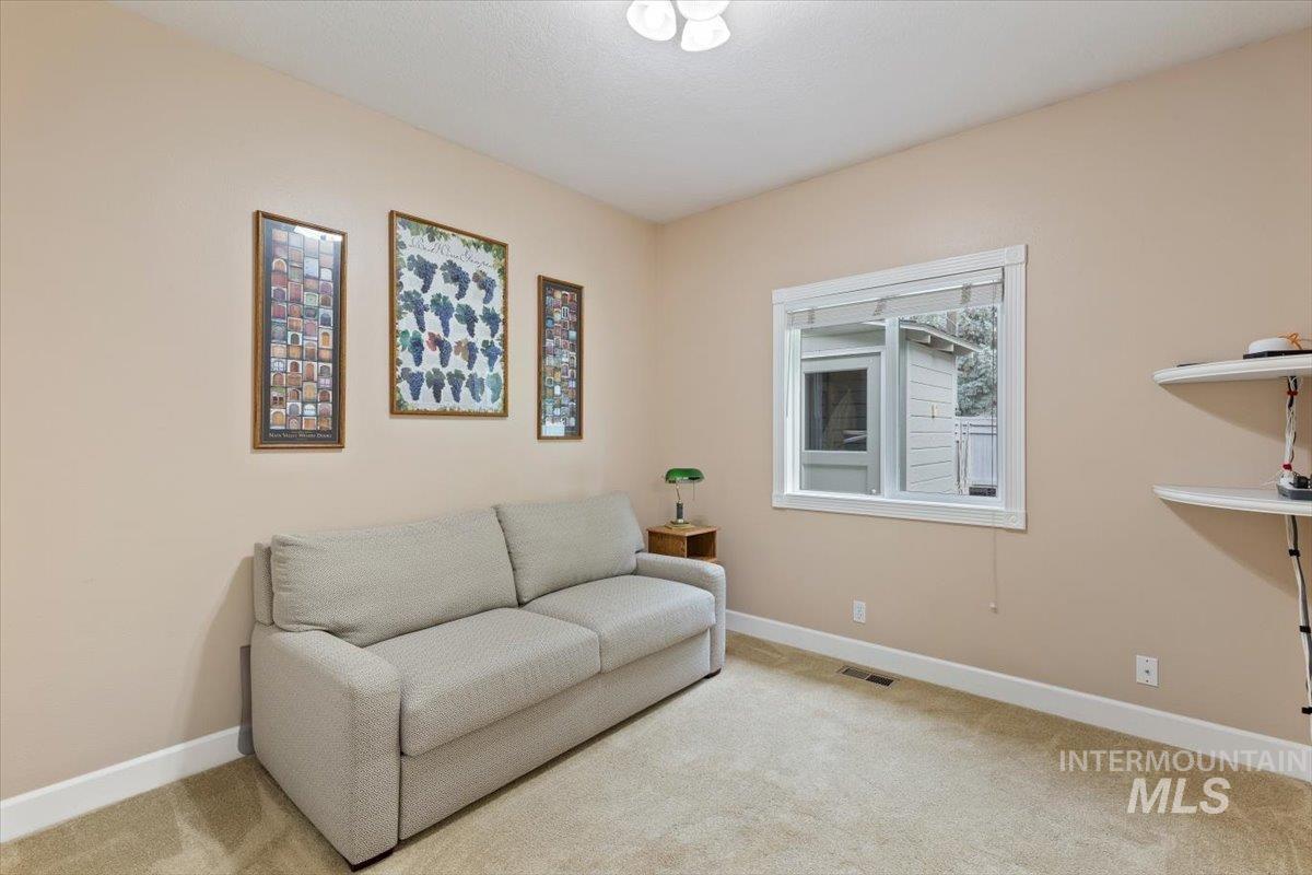 5184 North Greyloch Way Boise, ID 83704 - Photo 15 of 32 Carpeted room featuring a white-trimmed window, recessed wall shelving, and neutral wall paint