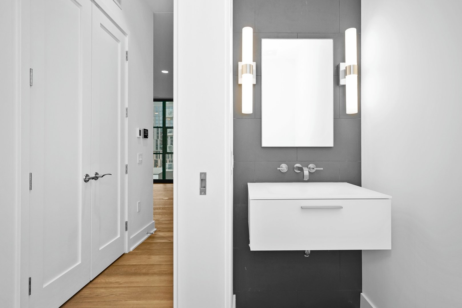 900 West Washington Boulevard, Unit 504 Chicago, IL 60607 - Photo 15 of 28 a bathroom with a sink a mirror and a toilet